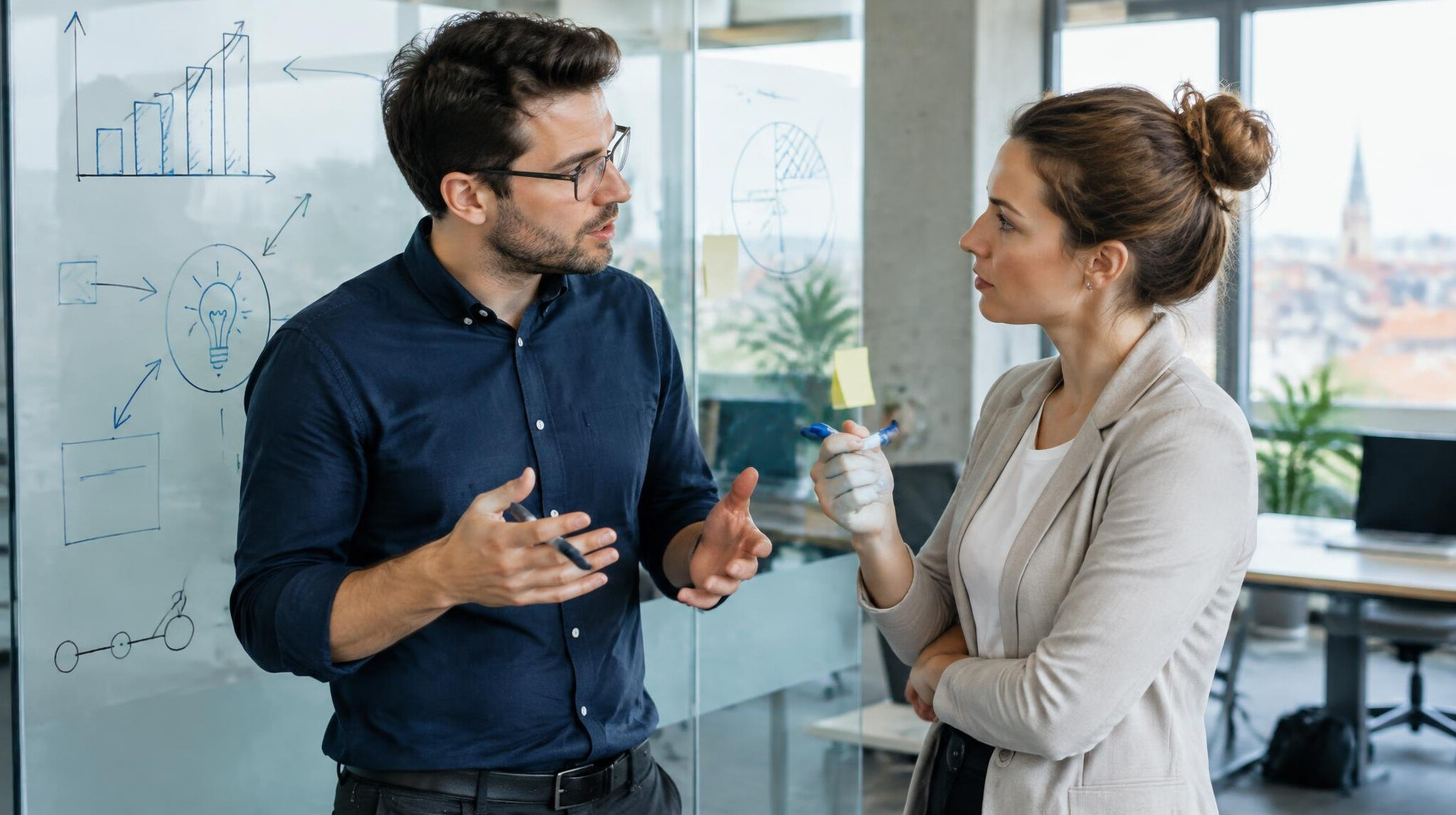 Two colleagues debating with charts during a business discussion